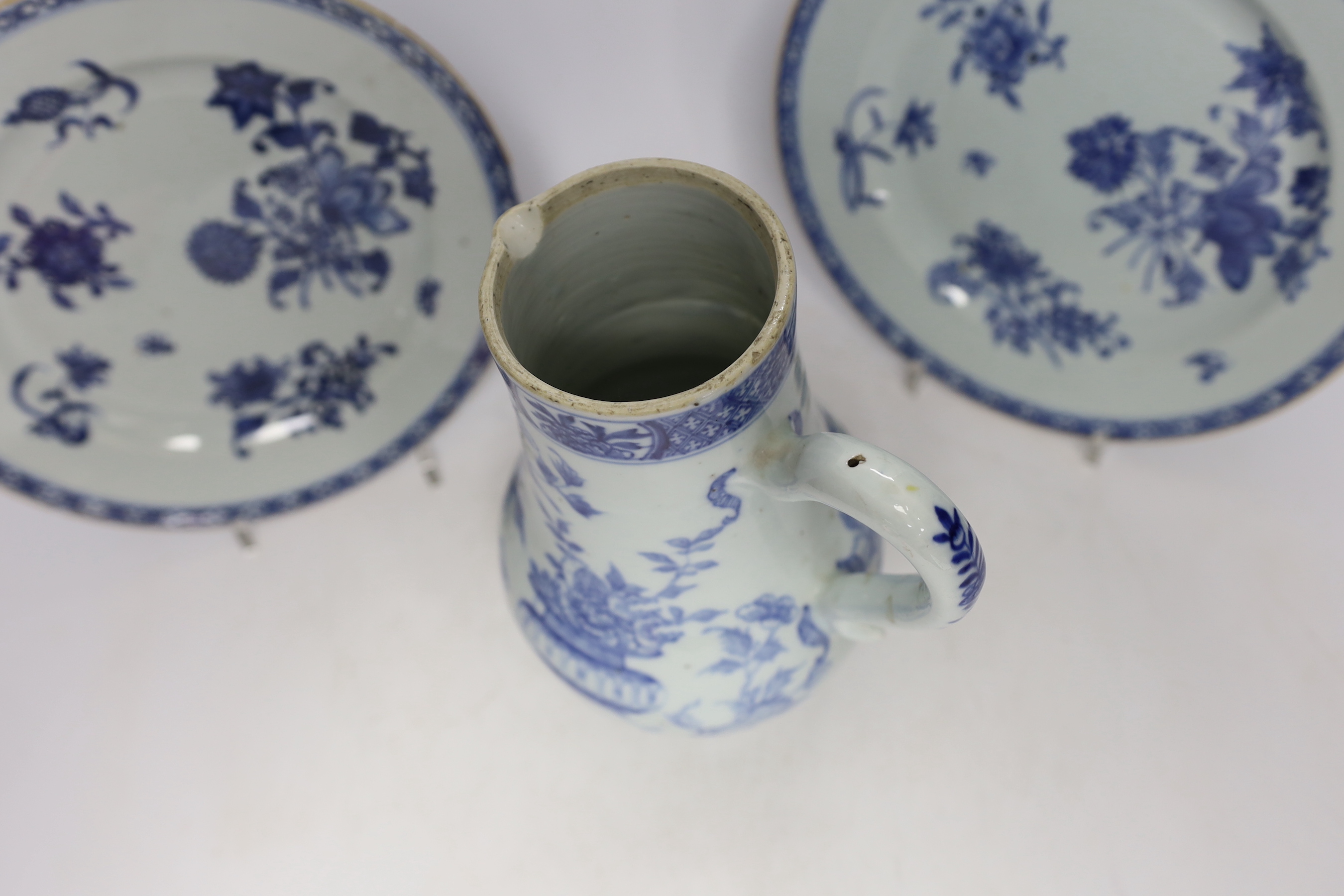 A Chinese 18th century reticulated double walled tea bowl and saucer, two blue and white plates and a jug (5)